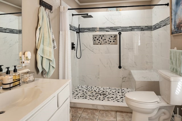 bathroom featuring toilet, a shower stall, and vanity