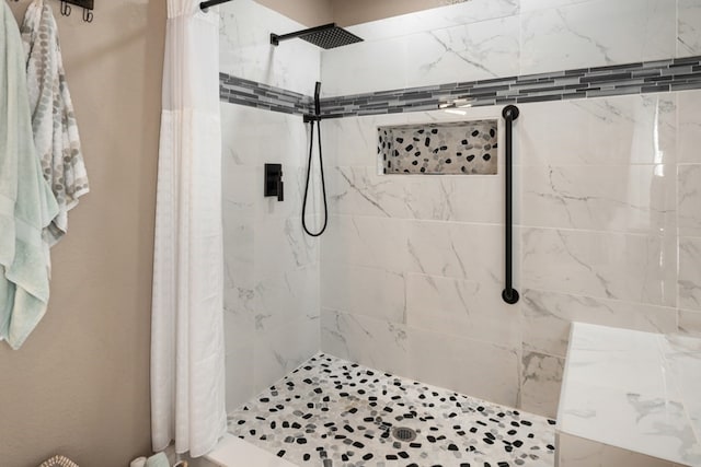 full bath with a tile shower