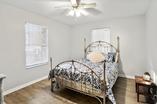 bedroom with ceiling fan, baseboards, and wood finished floors