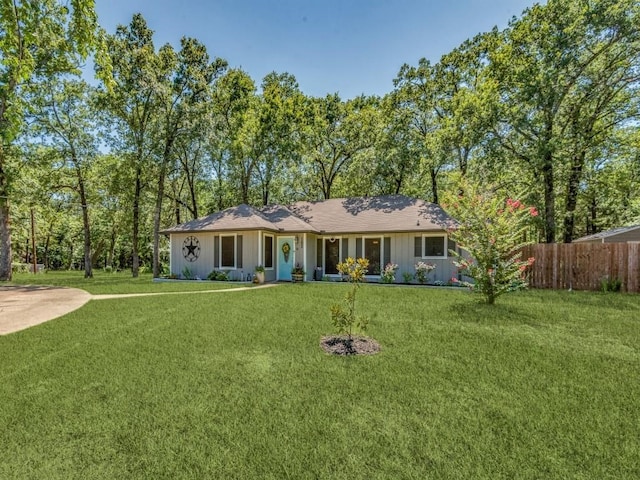 single story home with fence and a front lawn