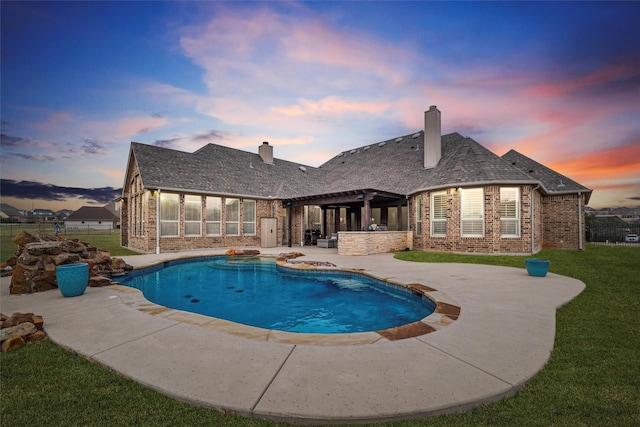 pool featuring a patio, a lawn, and a pergola