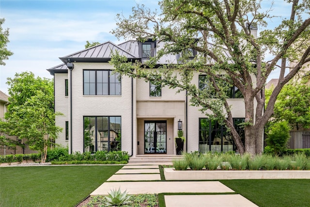3220 Colgate Ave, University Park, TX 75225 - view of front of property with a standing seam roof, brick siding, a front lawn, and metal roof