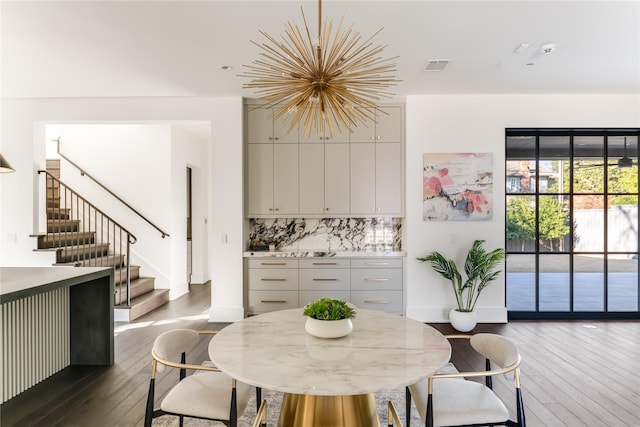 dining space with baseboards, visible vents, stairway, and dark wood-style flooring