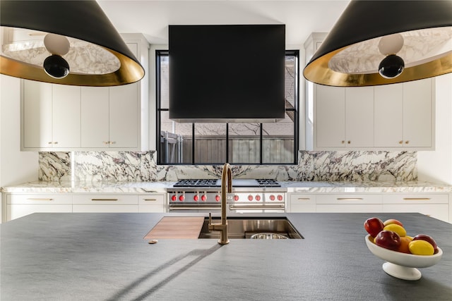 kitchen featuring range with two ovens, island exhaust hood, decorative backsplash, white cabinets, and extractor fan