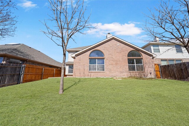 4965 Sunset Ridge Dr, Fort Worth, TX 76123 - back of property featuring a yard, a chimney, a fenced backyard, and brick siding