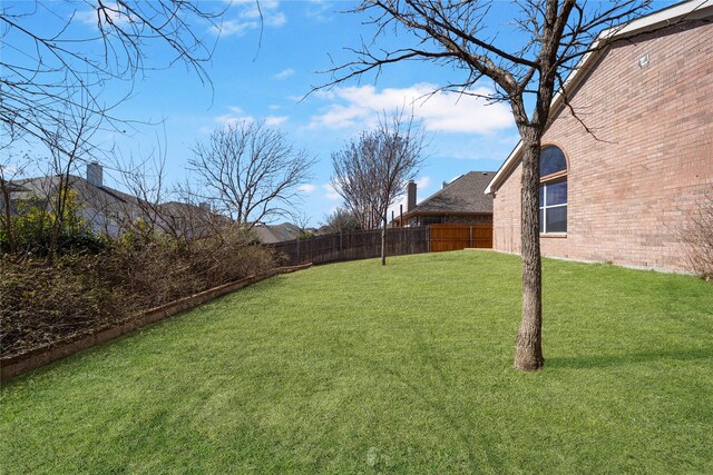 4965 Sunset Ridge Dr, Fort Worth, TX 76123 - back of property with a chimney, brick siding, a fenced backyard, and a yard