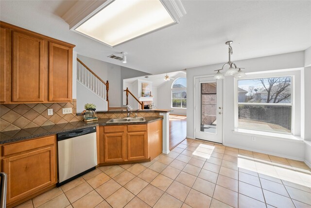 4965 Sunset Ridge Dr, Fort Worth, TX 76123 - kitchen featuring light tile patterned floors, backsplash, a peninsula, appliances with stainless steel finishes, and open floor plan