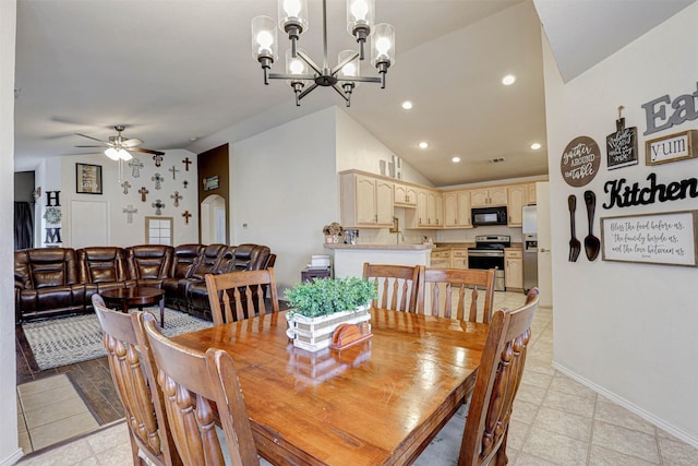 dining room with recessed lighting, baseboards, lofted ceiling, light floors, and ceiling fan with notable chandelier