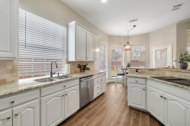 kitchen featuring a sink, visible vents, backsplash, and dishwasher