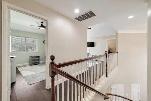 hall featuring recessed lighting, visible vents, wood finished floors, and an upstairs landing