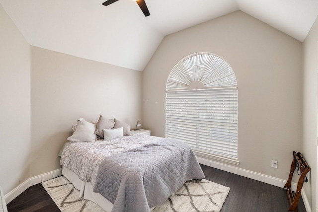 bedroom with ceiling fan, vaulted ceiling, baseboards, and wood finished floors