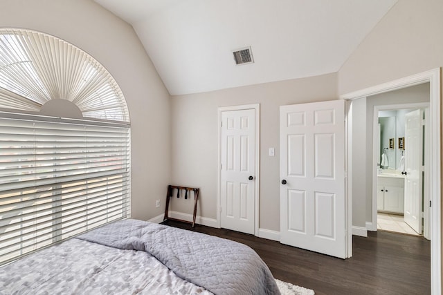 bedroom featuring lofted ceiling, a closet, visible vents, wood finished floors, and baseboards