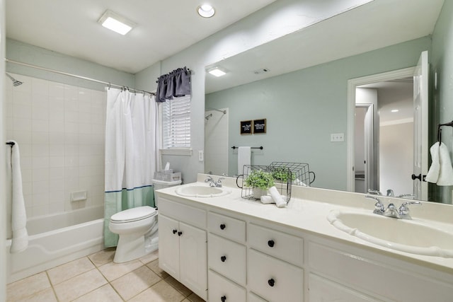 full bath with tile patterned flooring, double vanity, a sink, and shower / bath combo