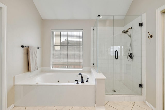 full bath with a stall shower, tile patterned flooring, and a jetted tub