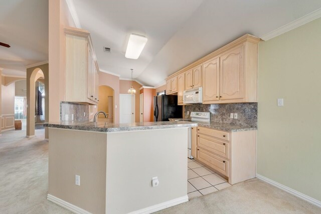 kitchen featuring white appliances, lofted ceiling, a peninsula, light brown cabinets, and a sink