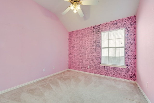 unfurnished room featuring light carpet, wallpapered walls, baseboards, and vaulted ceiling