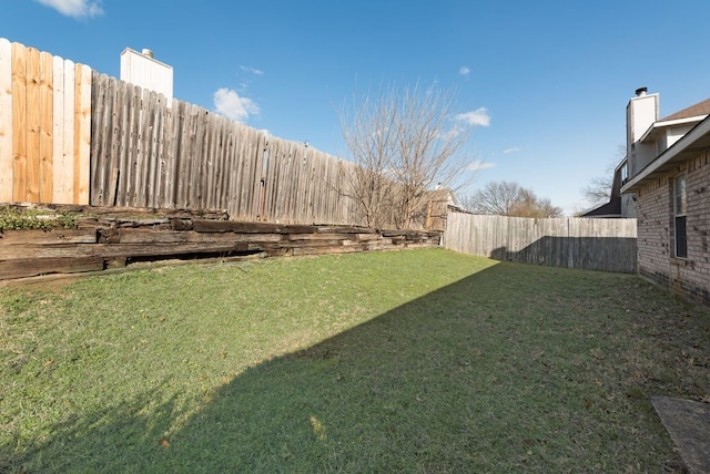 view of yard with a fenced backyard