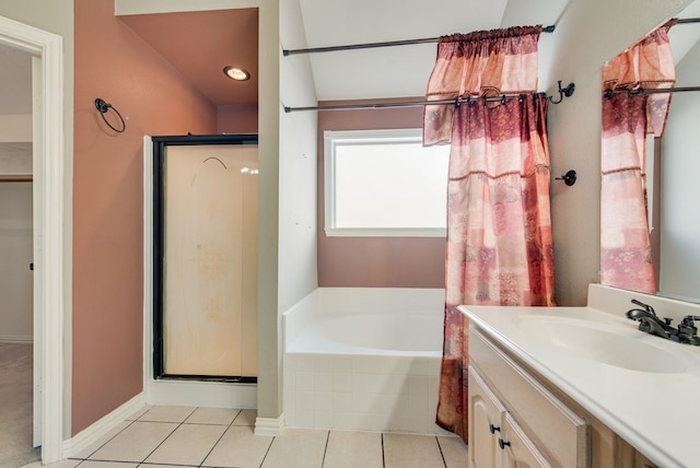 bathroom with a stall shower, a garden tub, vanity, and tile patterned floors