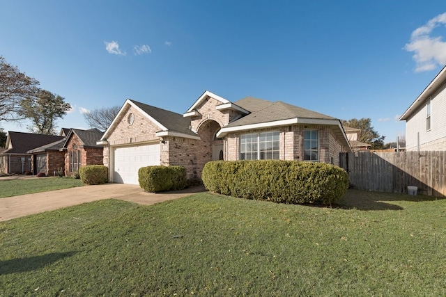 view of front of home featuring brick siding, fence, a garage, driveway, and a front lawn