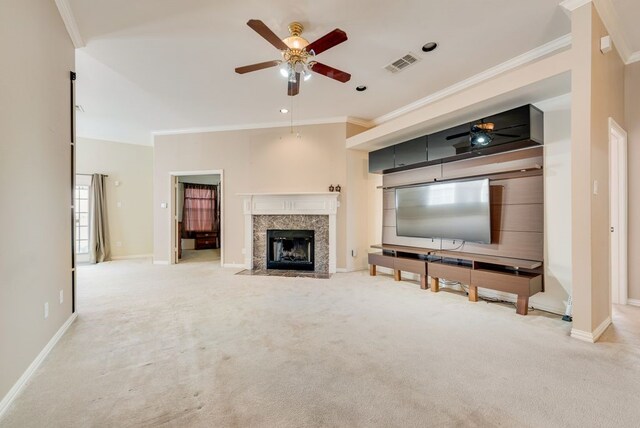 unfurnished living room with arched walkways, ceiling fan with notable chandelier, a premium fireplace, carpet flooring, and visible vents