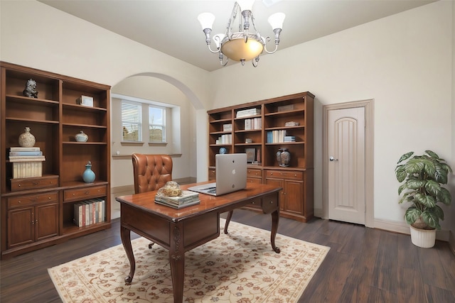 home office featuring baseboards, arched walkways, an inviting chandelier, and dark wood-style floors