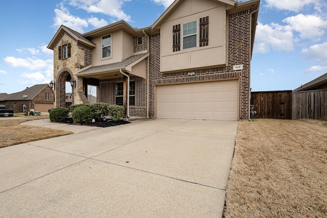 view of front of house with an attached garage, stucco siding, concrete driveway, stone siding, and brick siding