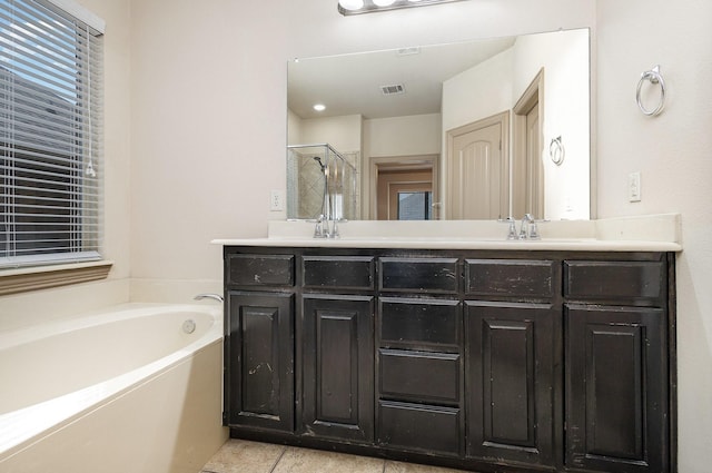 bathroom with visible vents, double vanity, a stall shower, a bath, and a sink