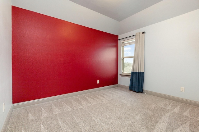 carpeted spare room with baseboards