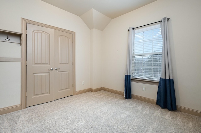 unfurnished bedroom with a closet, carpet floors, and baseboards