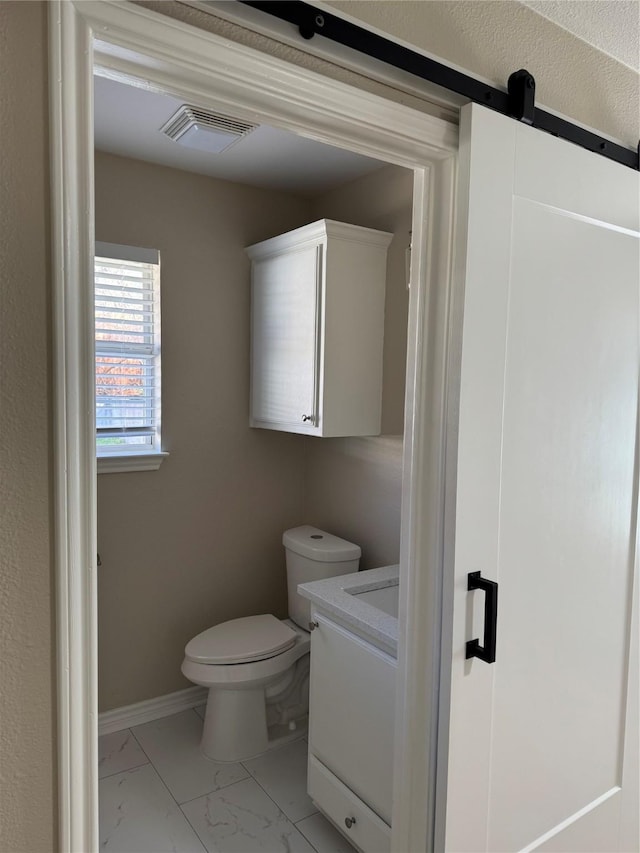 bathroom with marble finish floor, visible vents, toilet, vanity, and baseboards