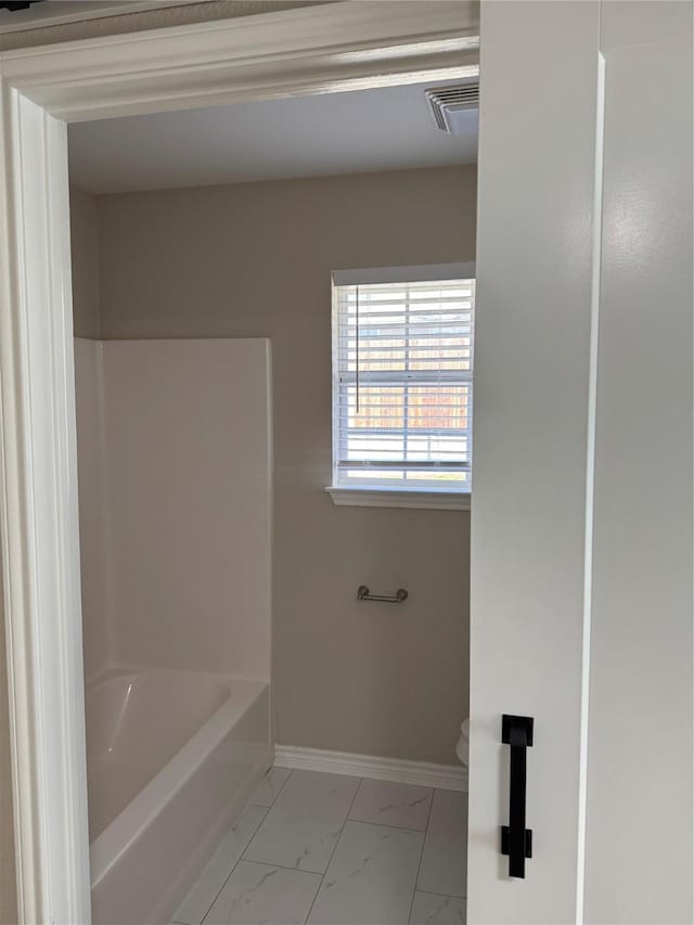 bathroom with toilet, marble finish floor, baseboards, and visible vents