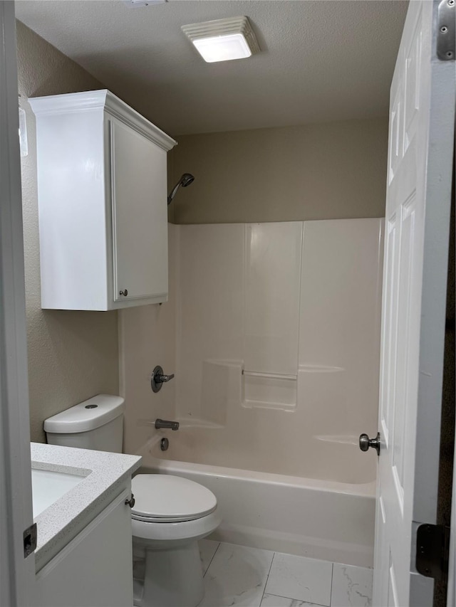 bathroom with toilet, marble finish floor, tub / shower combination, a textured ceiling, and vanity