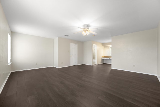 unfurnished living room with dark wood-style floors, ceiling fan, visible vents, and baseboards