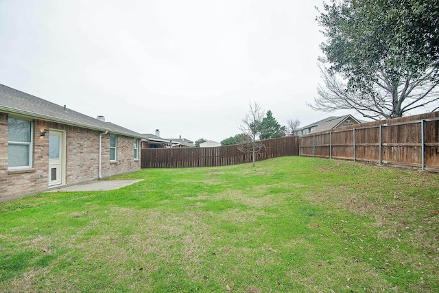 view of yard with a fenced backyard