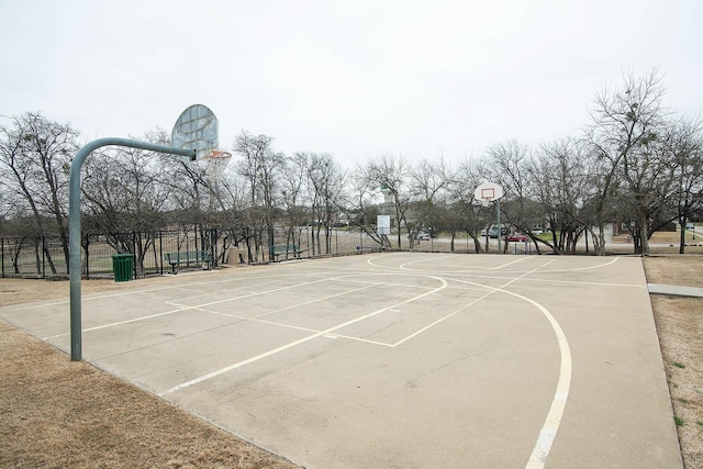 view of basketball court with community basketball court and fence