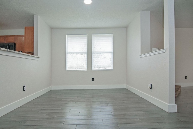 interior space with wood finish floors and baseboards