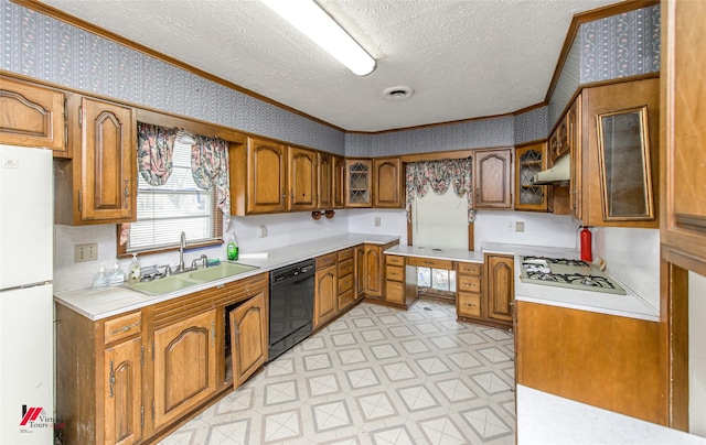 kitchen with wallpapered walls, white appliances, brown cabinetry, light floors, and a sink