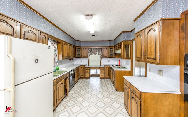 kitchen with ornamental molding, freestanding refrigerator, brown cabinets, and wallpapered walls