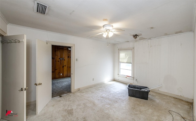 empty room featuring a ceiling fan, carpet, and visible vents