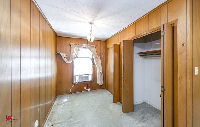 interior space featuring cooling unit and wooden walls