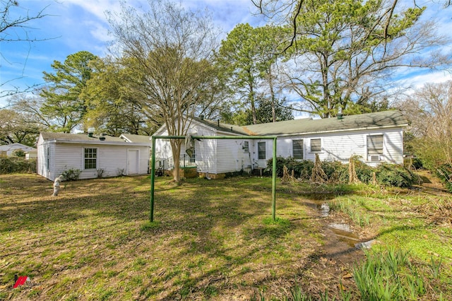 rear view of house featuring a lawn