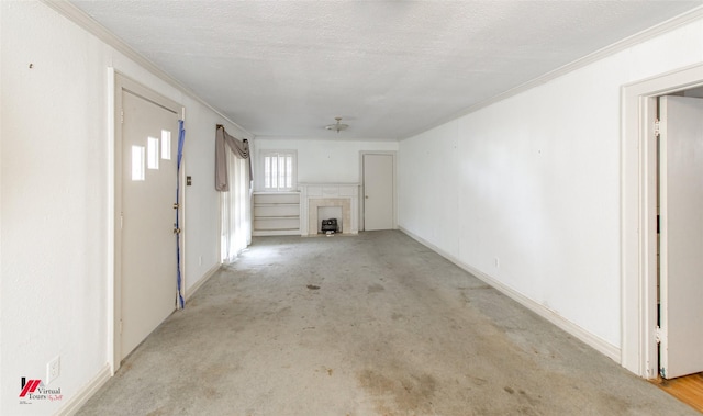 unfurnished living room featuring a textured ceiling, a fireplace, and crown molding