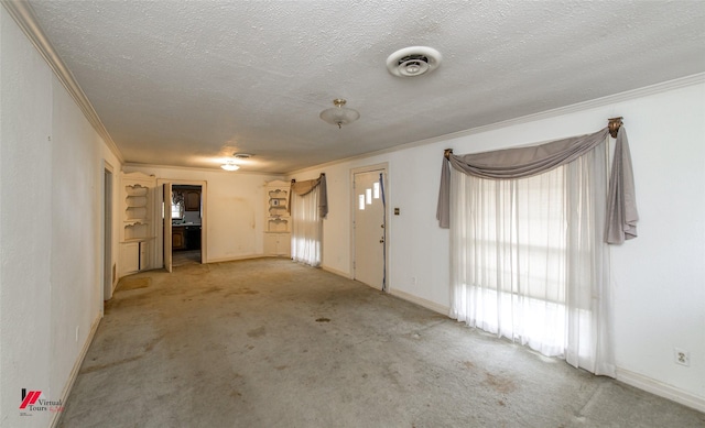 carpeted entrance foyer featuring baseboards, visible vents, a textured ceiling, and ornamental molding