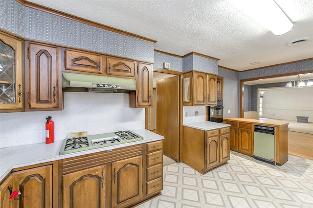 kitchen with crown molding, white gas stovetop, black oven, under cabinet range hood, and wallpapered walls