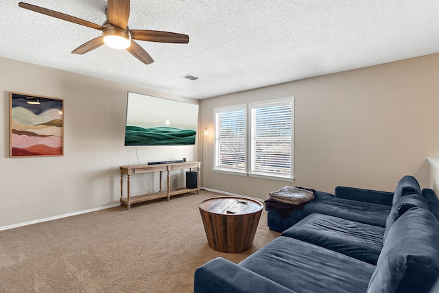 living area with carpet, visible vents, ceiling fan, a textured ceiling, and baseboards