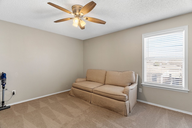 living area featuring light carpet, a wealth of natural light, and baseboards