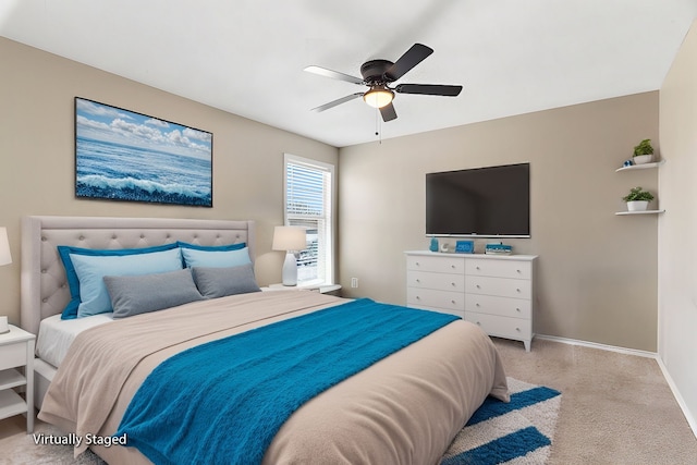 carpeted bedroom featuring a ceiling fan and baseboards