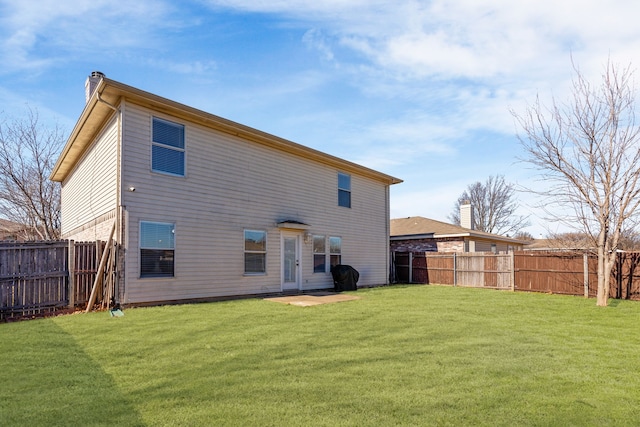 back of property with a yard and a fenced backyard