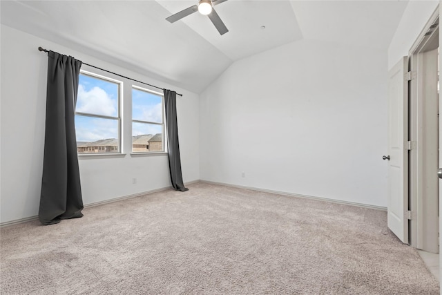 unfurnished room featuring lofted ceiling, carpet flooring, ceiling fan, and baseboards