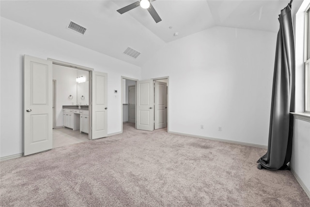 unfurnished bedroom with lofted ceiling, light carpet, and visible vents